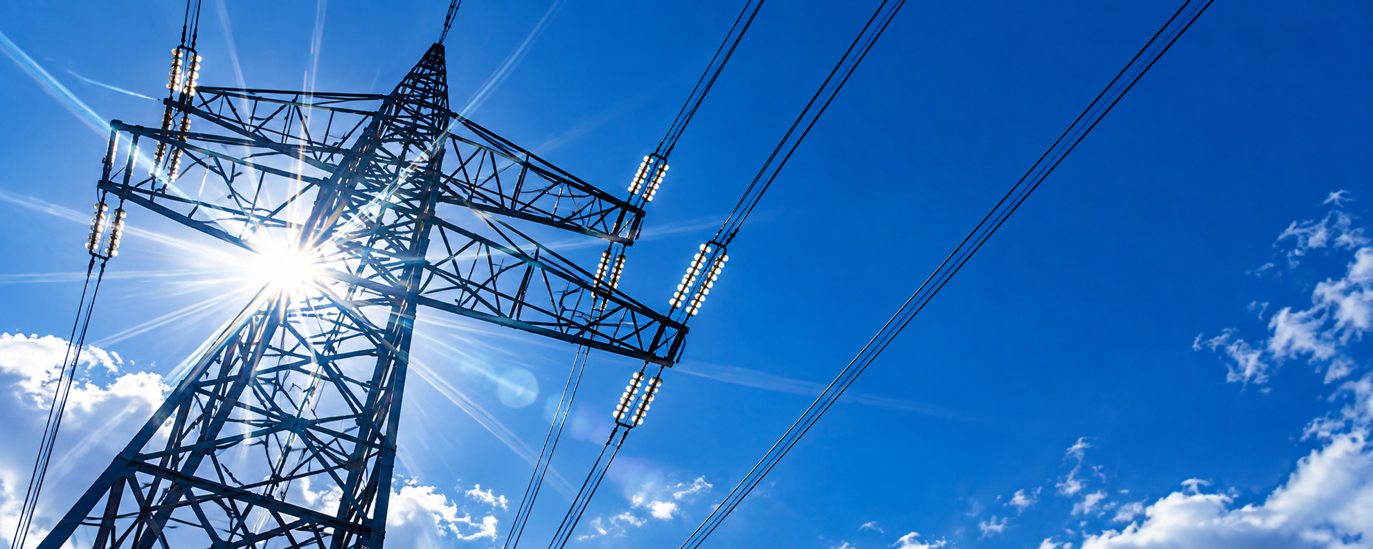 An electricity transmission tower against a bright blue sky. [TODO: ta]